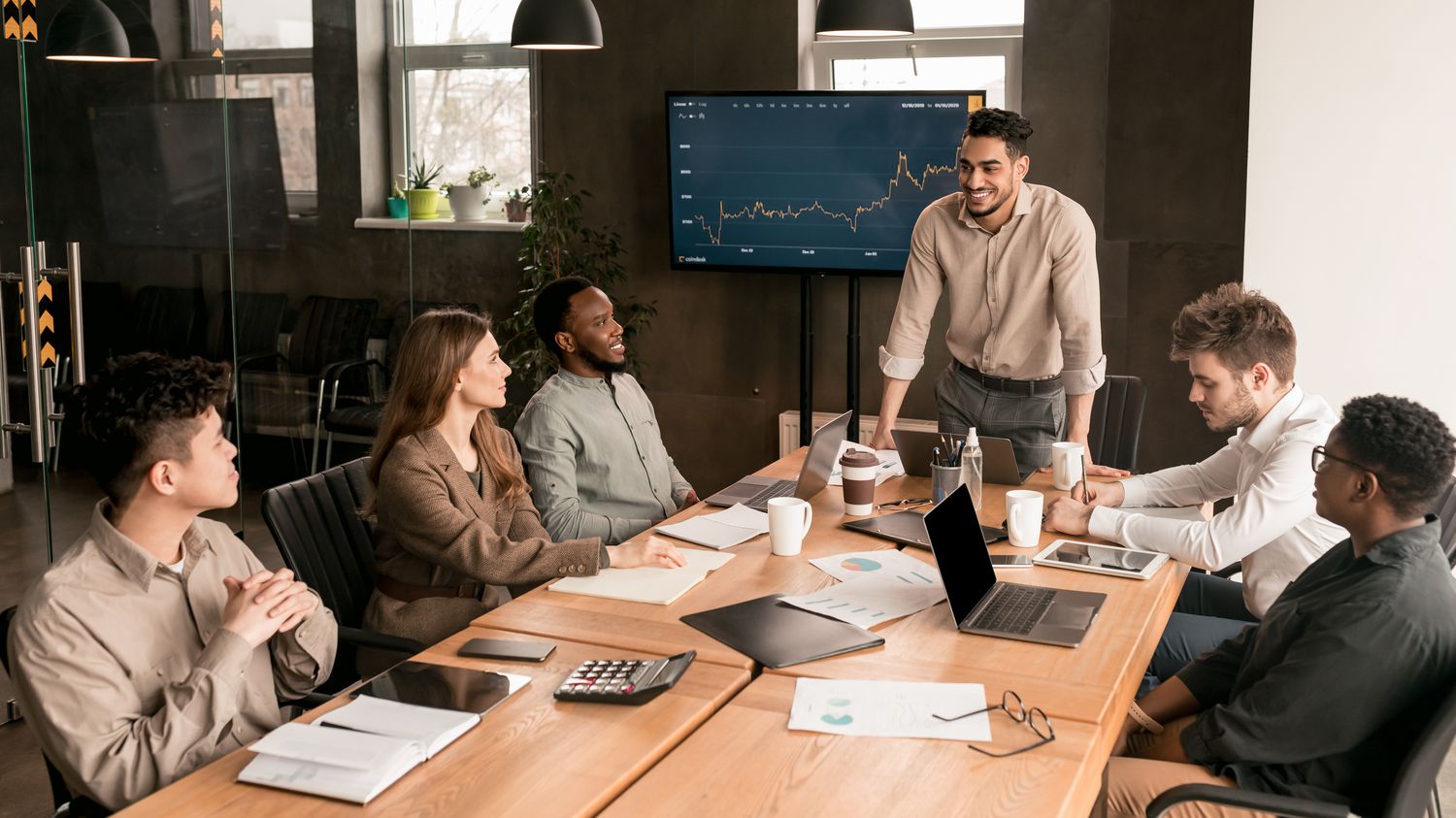 Decision-makers in a real UK workplace or boardroom. Human and considered.